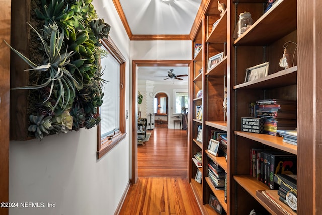 hall with ornamental molding and hardwood / wood-style flooring