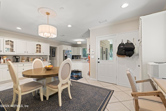 dining area with ornamental molding and light tile floors