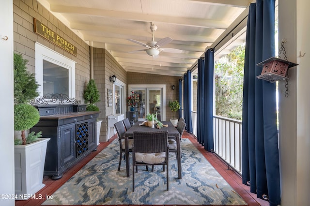 sunroom featuring vaulted ceiling with beams, plenty of natural light, and ceiling fan