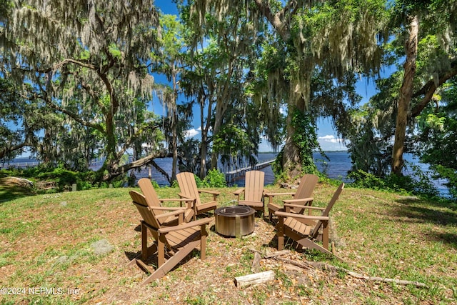 view of yard with a water view and a fire pit