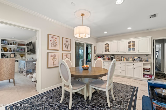 tiled dining space featuring crown molding