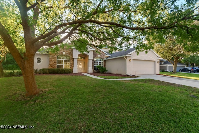 ranch-style house featuring a front yard and a garage