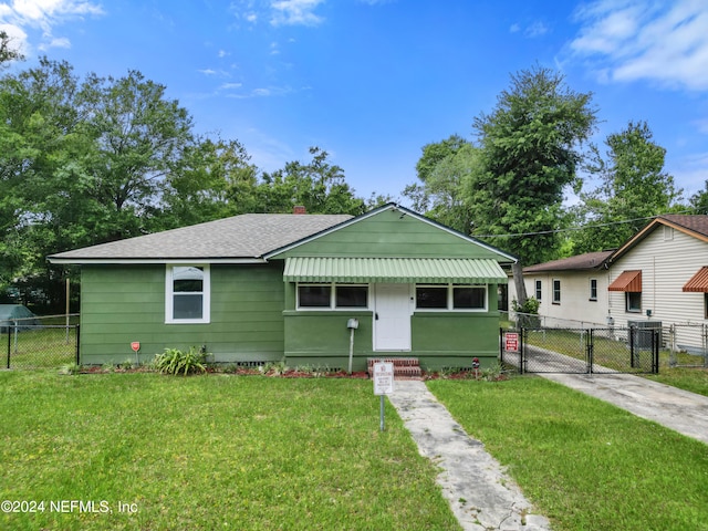 bungalow-style home with a front yard