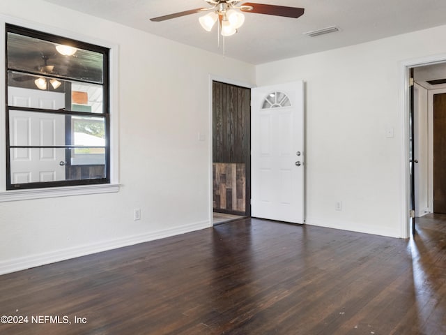 unfurnished room featuring ceiling fan and dark hardwood / wood-style flooring