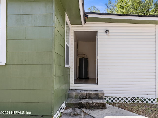 doorway to property featuring water heater