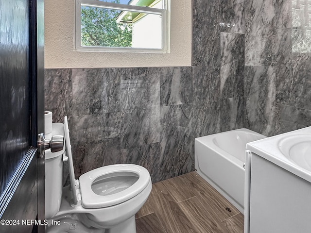 bathroom featuring tile floors, vanity, toilet, and tile walls