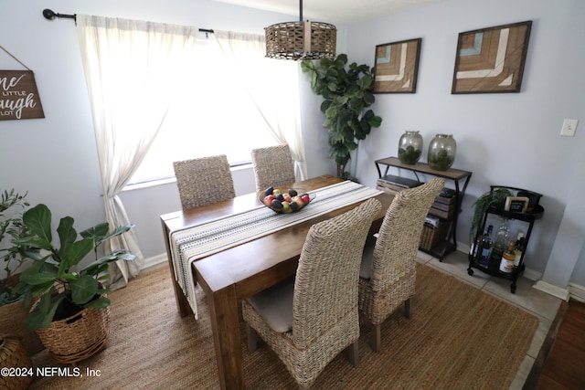 dining space with wood-type flooring