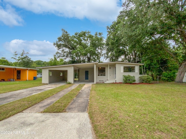 ranch-style home with a front lawn and a carport