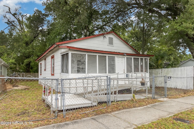 view of front of house featuring a sunroom