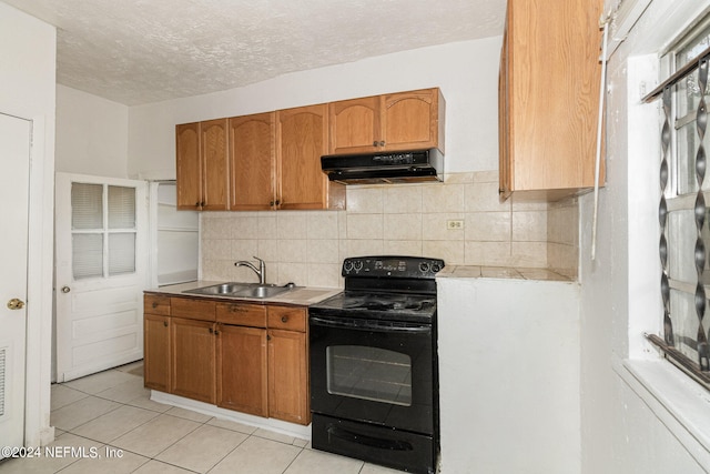 kitchen with black range with electric cooktop, backsplash, fume extractor, sink, and light tile floors