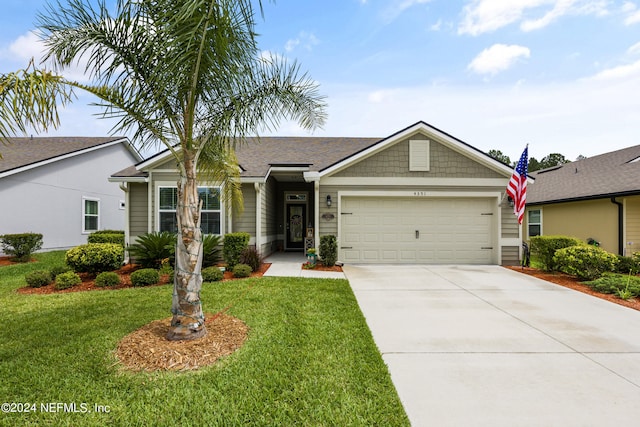 ranch-style home featuring a front lawn and a garage