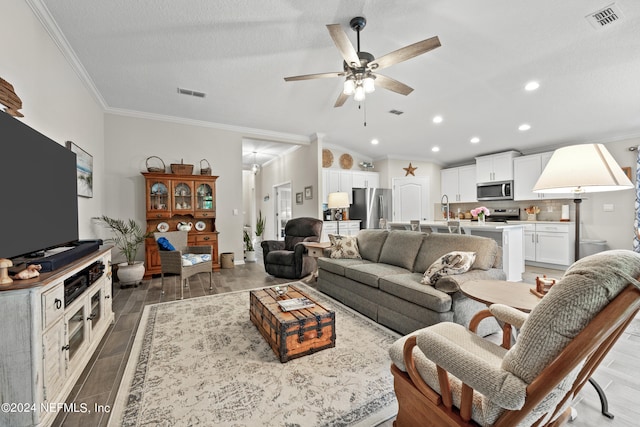 living room with sink, ornamental molding, ceiling fan, and hardwood / wood-style floors