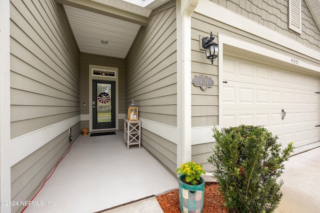 view of exterior entry with a garage