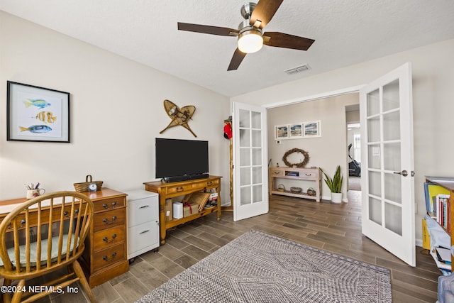 home office with french doors, ceiling fan, a textured ceiling, and dark hardwood / wood-style flooring