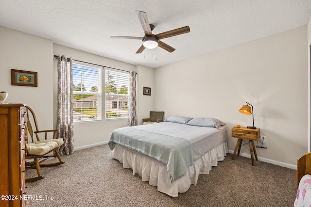 bedroom featuring a textured ceiling, ceiling fan, and carpet floors