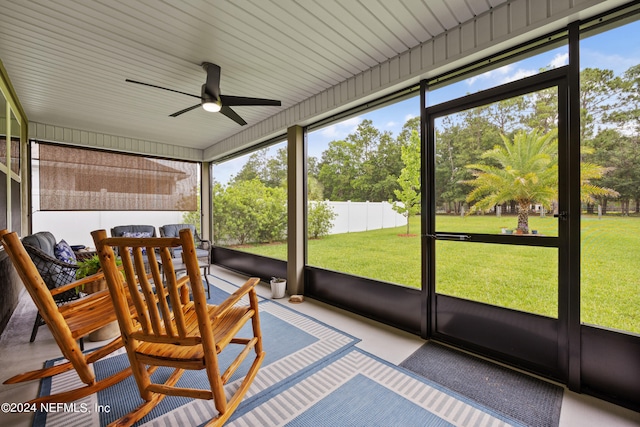 unfurnished sunroom featuring ceiling fan