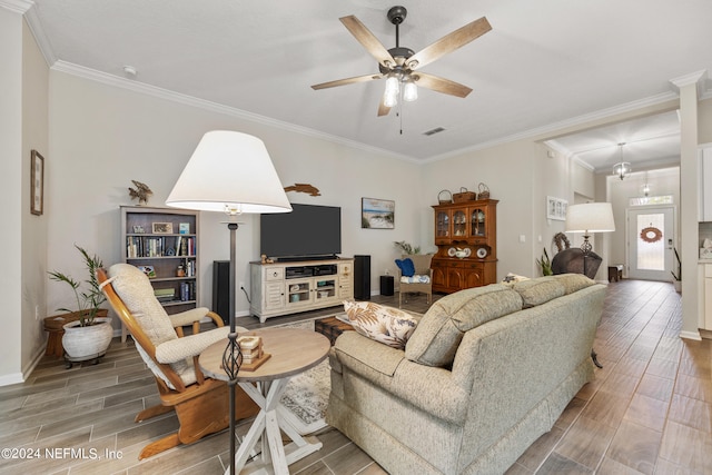 living room featuring hardwood / wood-style floors, ceiling fan, and crown molding