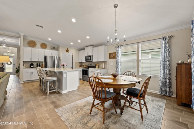 dining room with a notable chandelier, crown molding, vaulted ceiling, and light hardwood / wood-style flooring