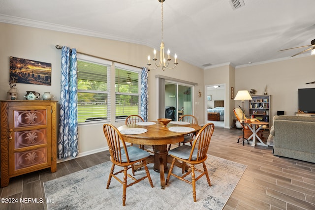 dining room with ceiling fan with notable chandelier, lofted ceiling, hardwood / wood-style flooring, and ornamental molding