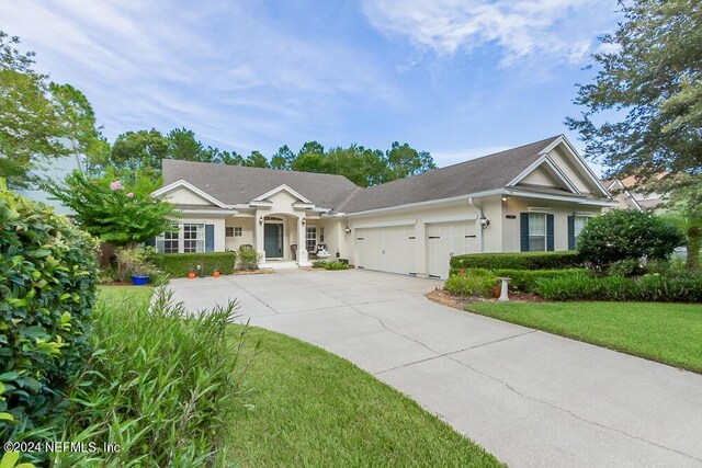 view of front of house with a garage and a front lawn