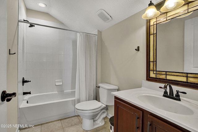 full bathroom featuring vanity, toilet, a textured ceiling, and tile patterned floors