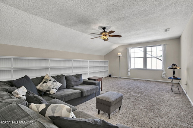 living room featuring a textured ceiling, lofted ceiling, carpet flooring, and ceiling fan