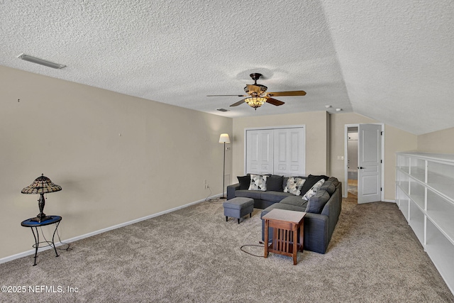 carpeted living room featuring a textured ceiling, vaulted ceiling, and ceiling fan