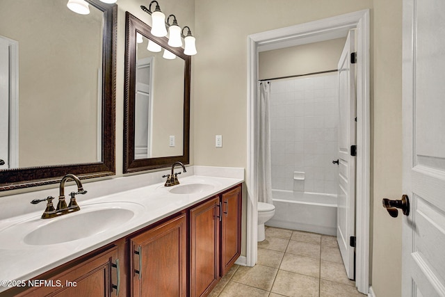 full bathroom with tile patterned floors, toilet, vanity, and shower / tub combo