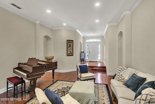 living room featuring dark wood-type flooring and crown molding