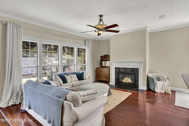 living room with crown molding, dark hardwood / wood-style flooring, and a textured ceiling