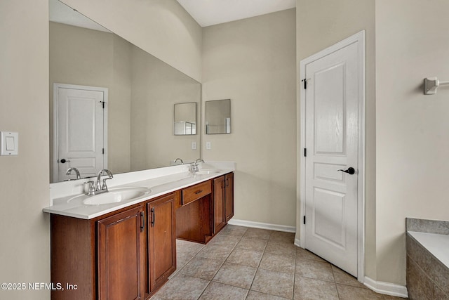 bathroom with vanity, a relaxing tiled tub, and tile patterned flooring