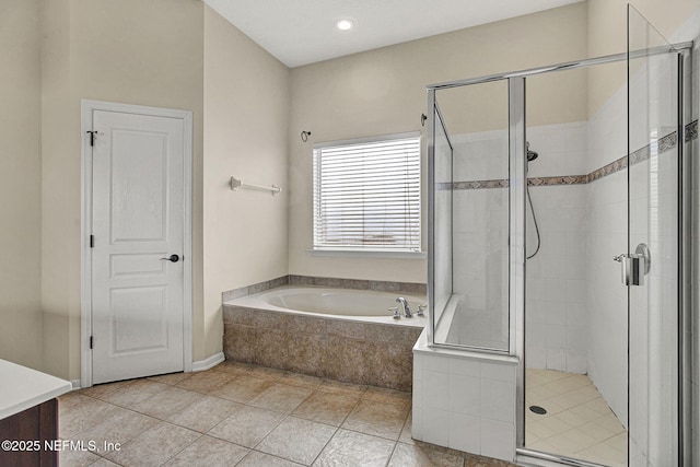 bathroom featuring tile patterned floors and separate shower and tub