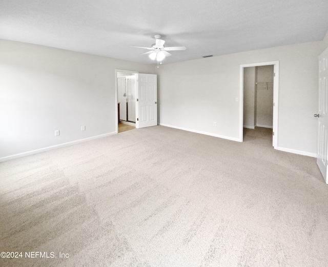 unfurnished room featuring ceiling fan and carpet floors