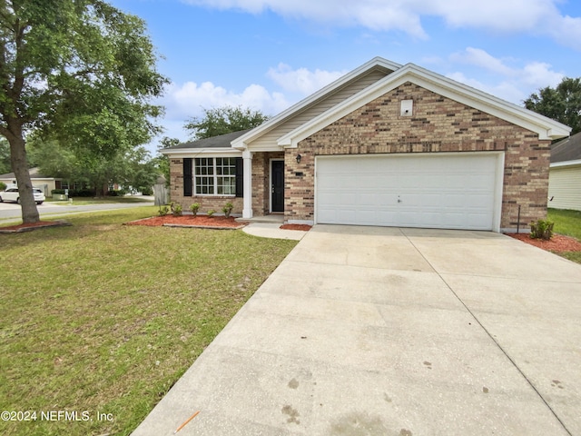 view of front of home featuring a garage and a front lawn