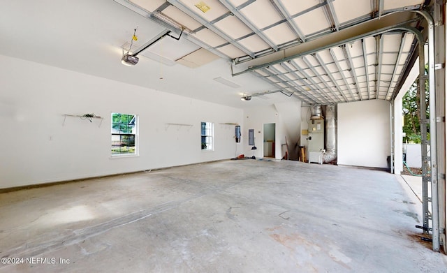 garage featuring heating unit and a garage door opener