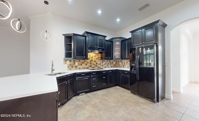 kitchen with sink, backsplash, kitchen peninsula, light tile patterned floors, and black appliances