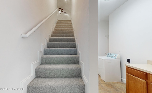 staircase featuring ceiling fan and washer / dryer