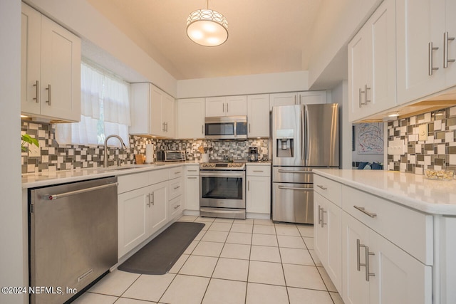 kitchen featuring tasteful backsplash, white cabinetry, sink, and appliances with stainless steel finishes