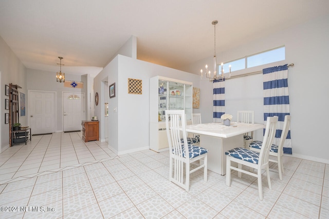 dining room with light tile patterned floors and a notable chandelier