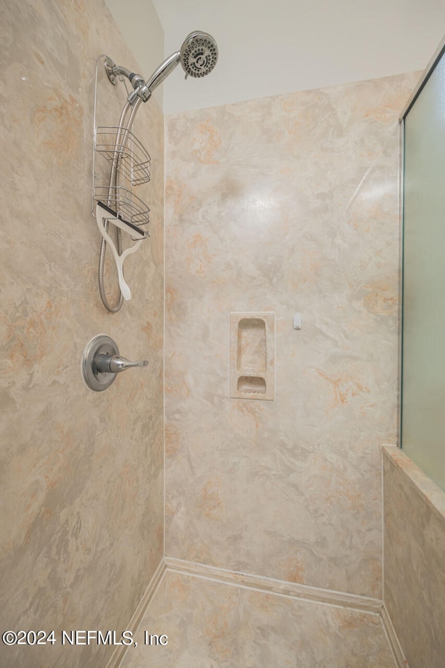 bathroom with tiled shower