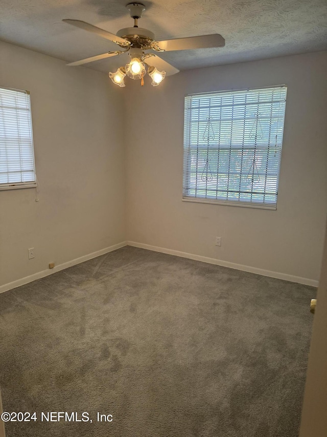 carpeted empty room with ceiling fan