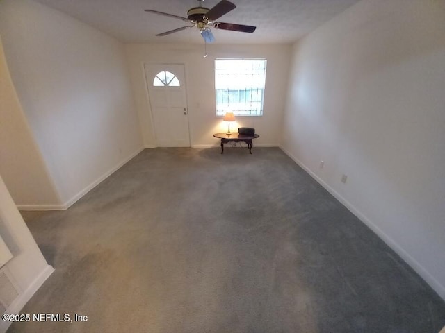 carpeted foyer entrance with ceiling fan