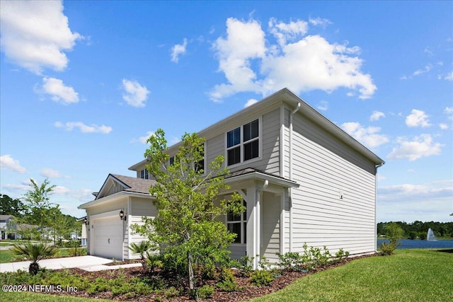 view of front of home with a front yard and a garage