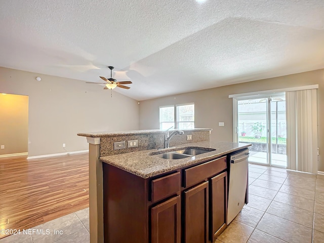 kitchen featuring a textured ceiling, dishwasher, sink, and light hardwood / wood-style flooring