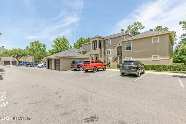 view of car parking with a garage