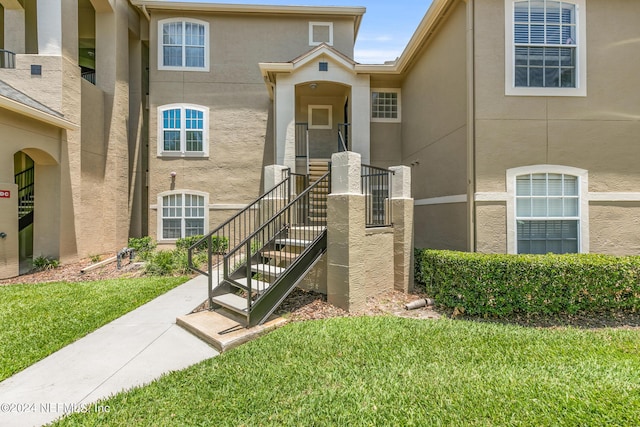 property entrance with a yard