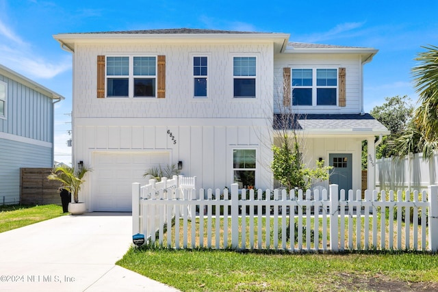 view of front of house with a garage and a front lawn