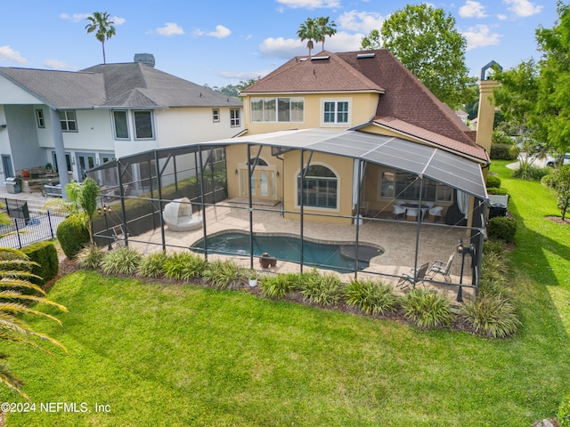 view of pool featuring glass enclosure, a patio area, and a lawn