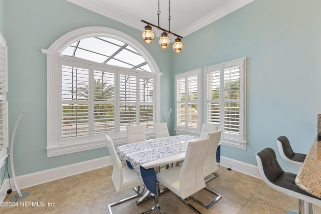 dining area featuring tile flooring, a healthy amount of sunlight, and crown molding