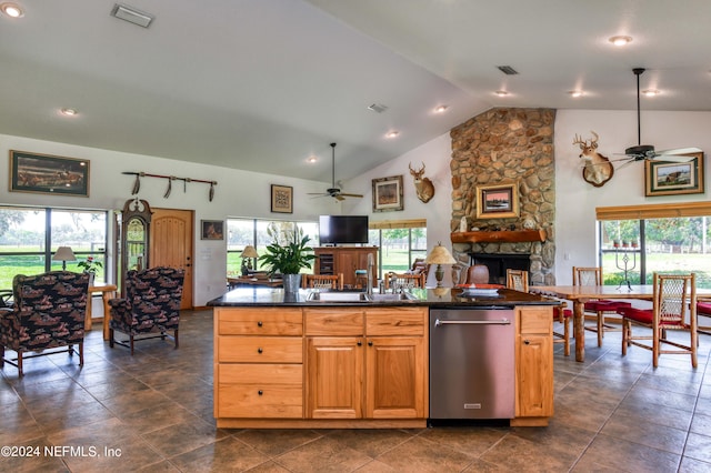 kitchen featuring ceiling fan, a healthy amount of sunlight, and a stone fireplace